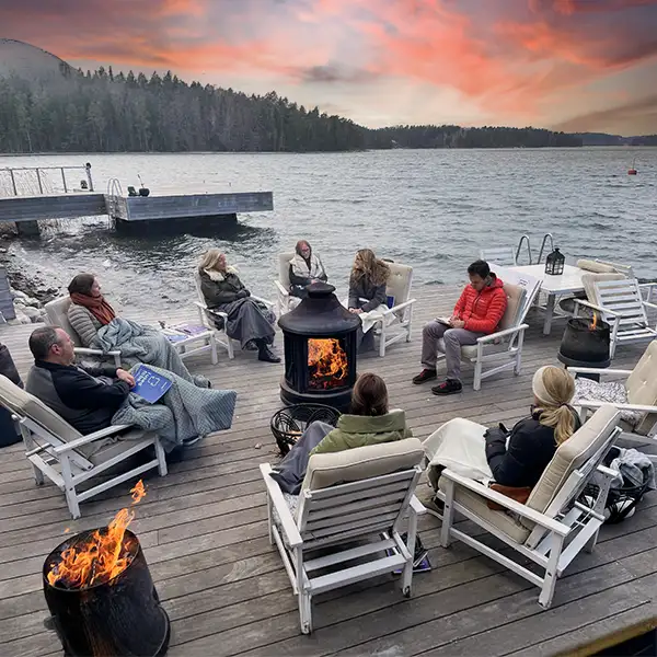 a group of people sitting by a fireplace